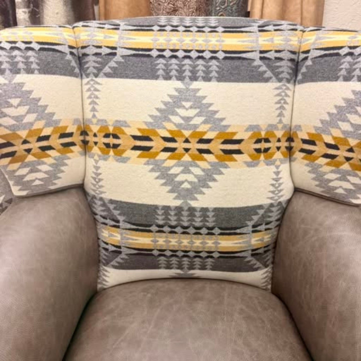 close up of the wingback chair inside back showing the fabric and leather seat and arms