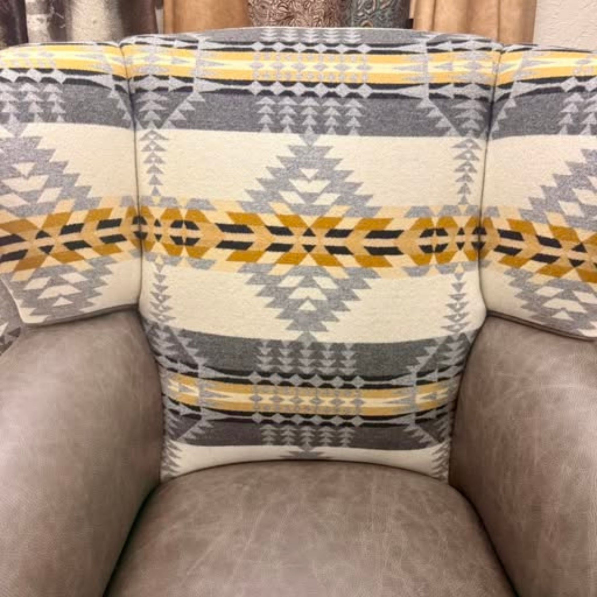 close up of the wingback chair inside back showing the fabric and leather seat and arms