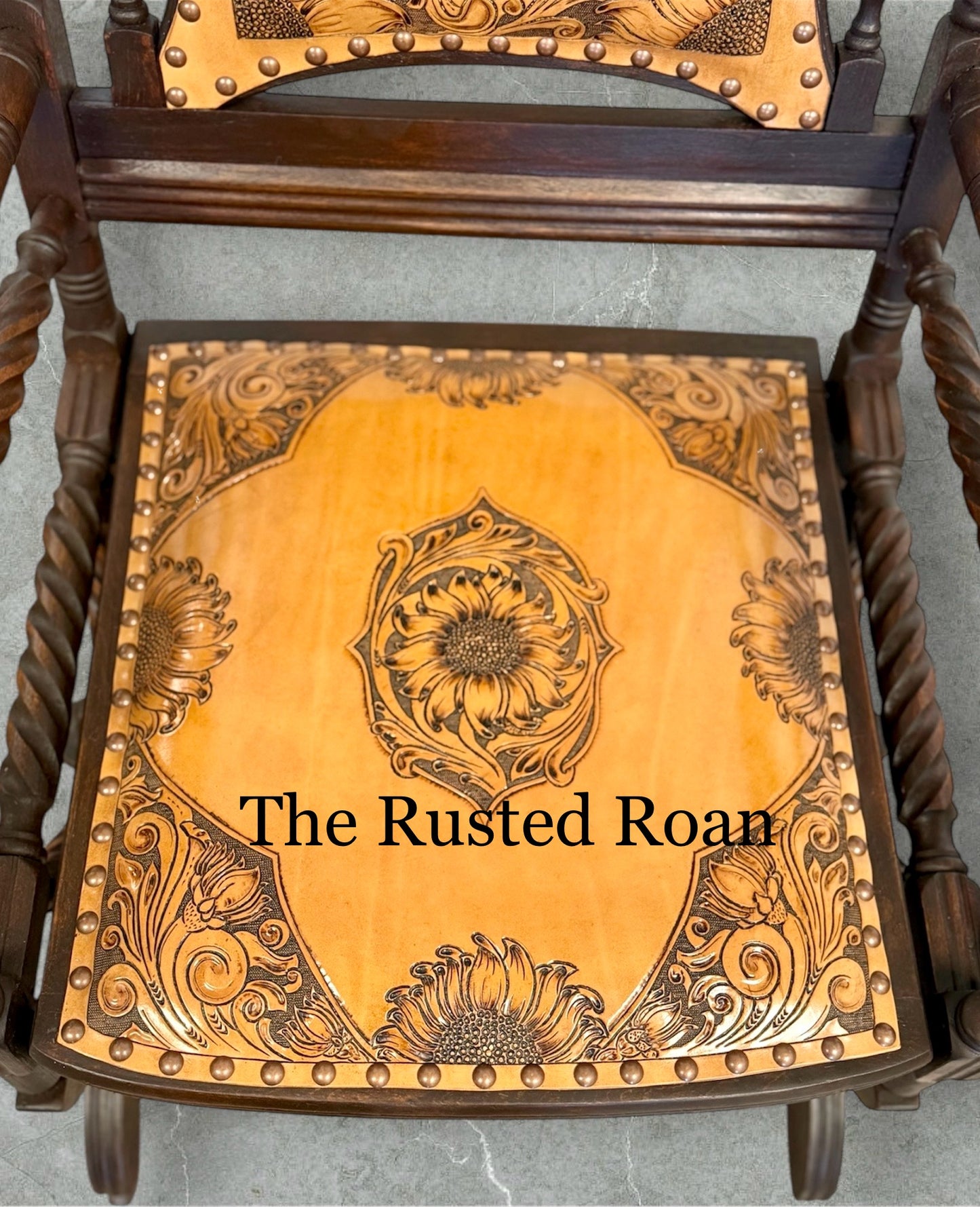 hand tooled sunflower leather upholstered rocking chair close up of the seat