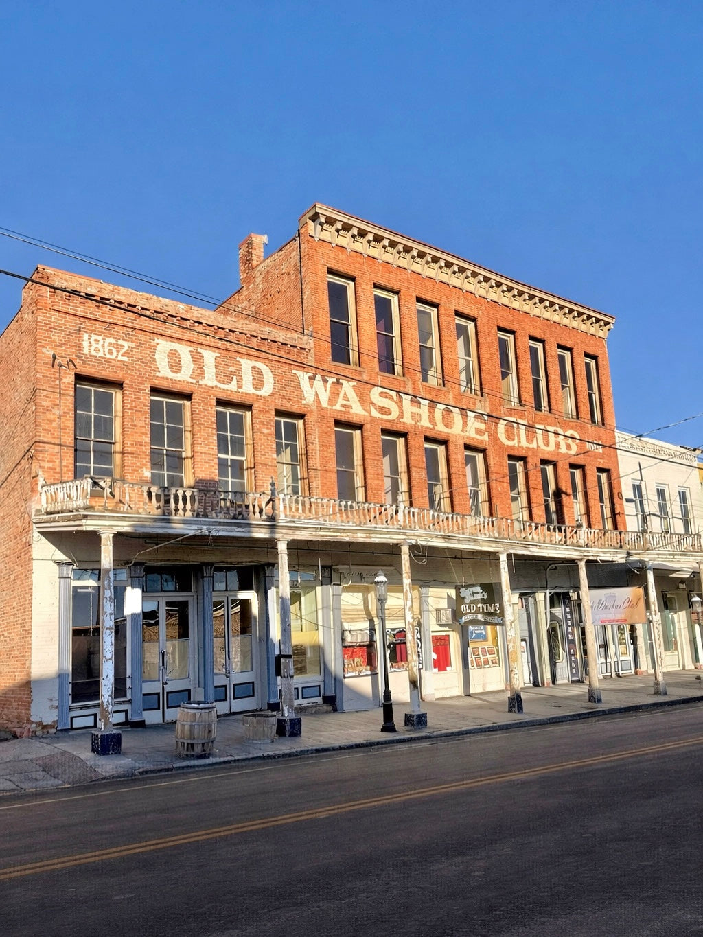 Brick building with 'Old Washoe Club' sign on a clear day