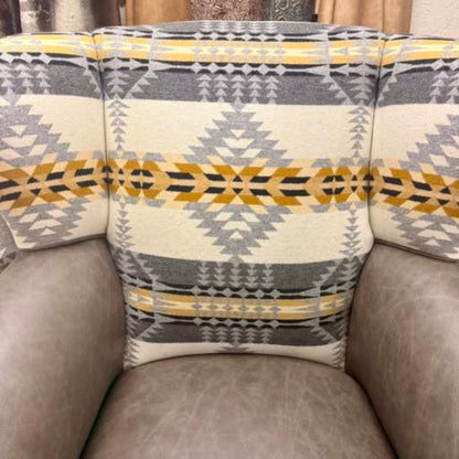 close up of the wingback chair inside back showing the fabric and leather seat and arms