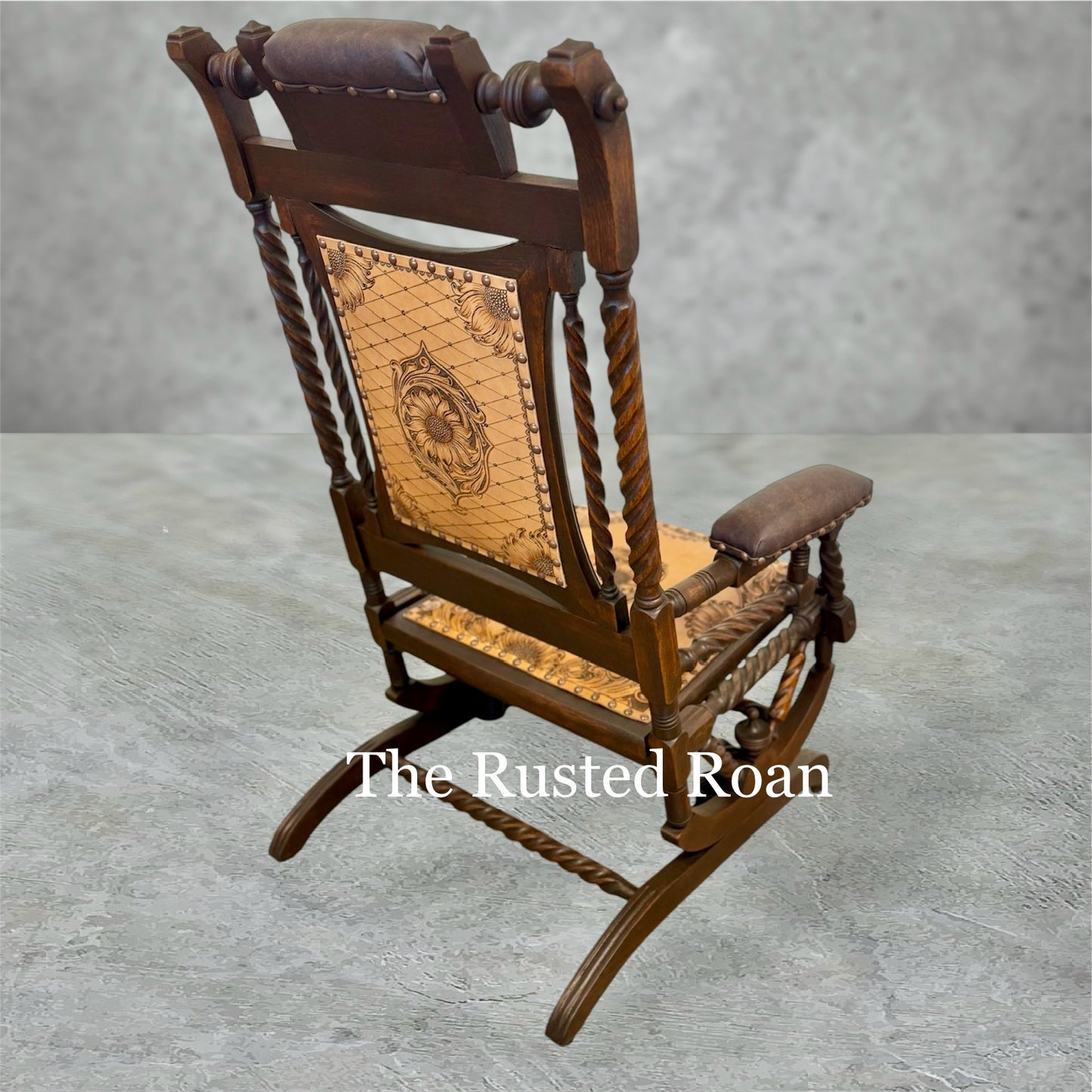 hand tooled sunflower leather upholstered rocking chair back view on an angle