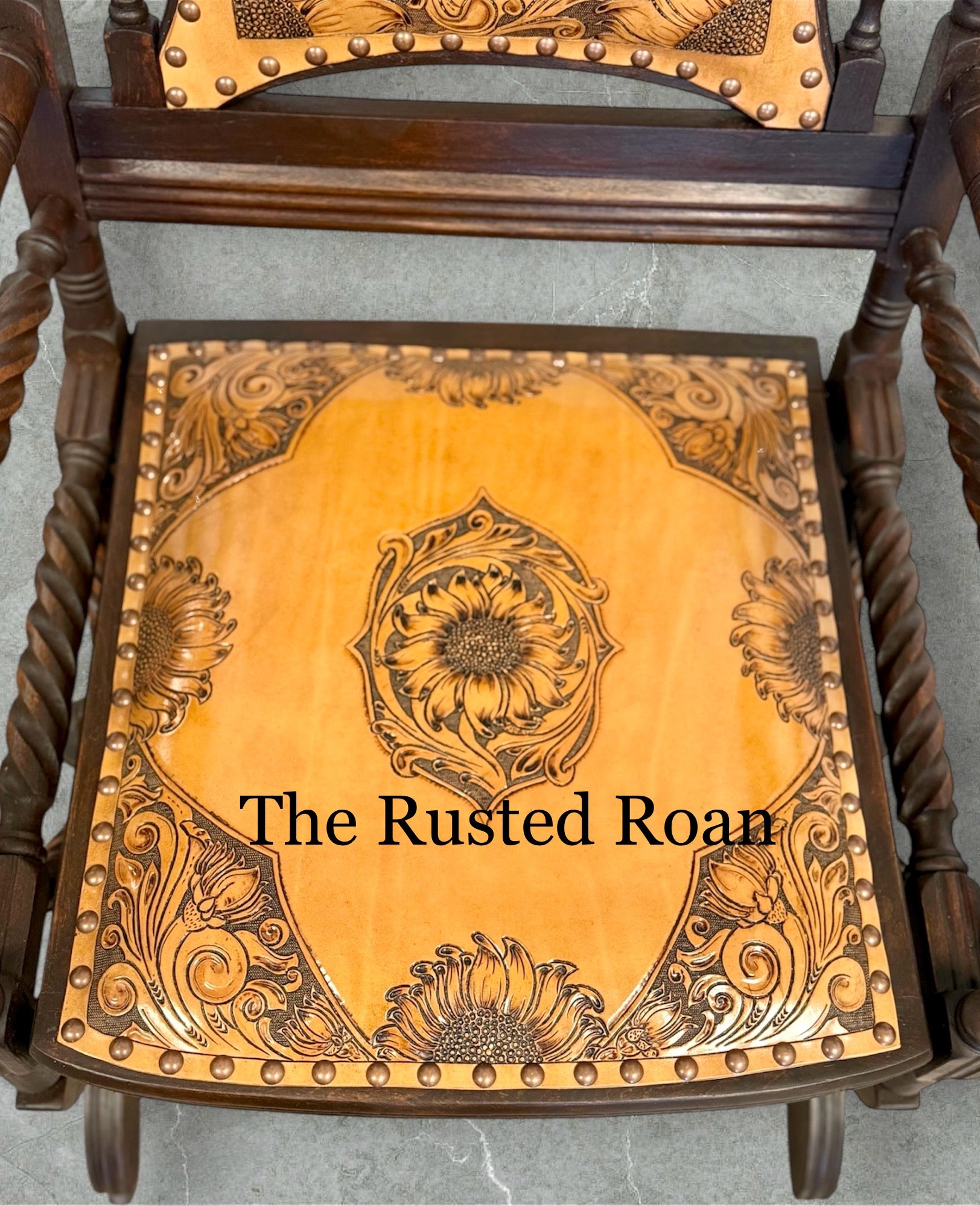 hand tooled sunflower leather upholstered rocking chair close up of the seat